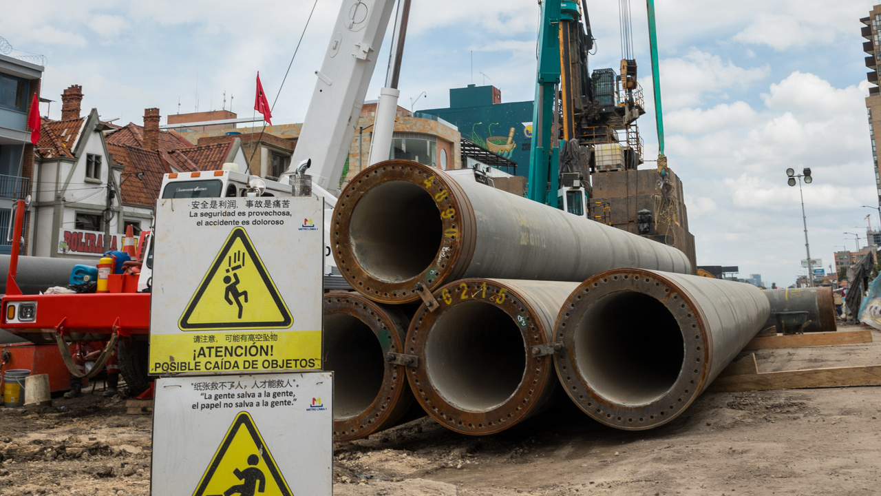 Piloteadora con pilotes PHC para hincar y señales de precaución para evitar accidentes